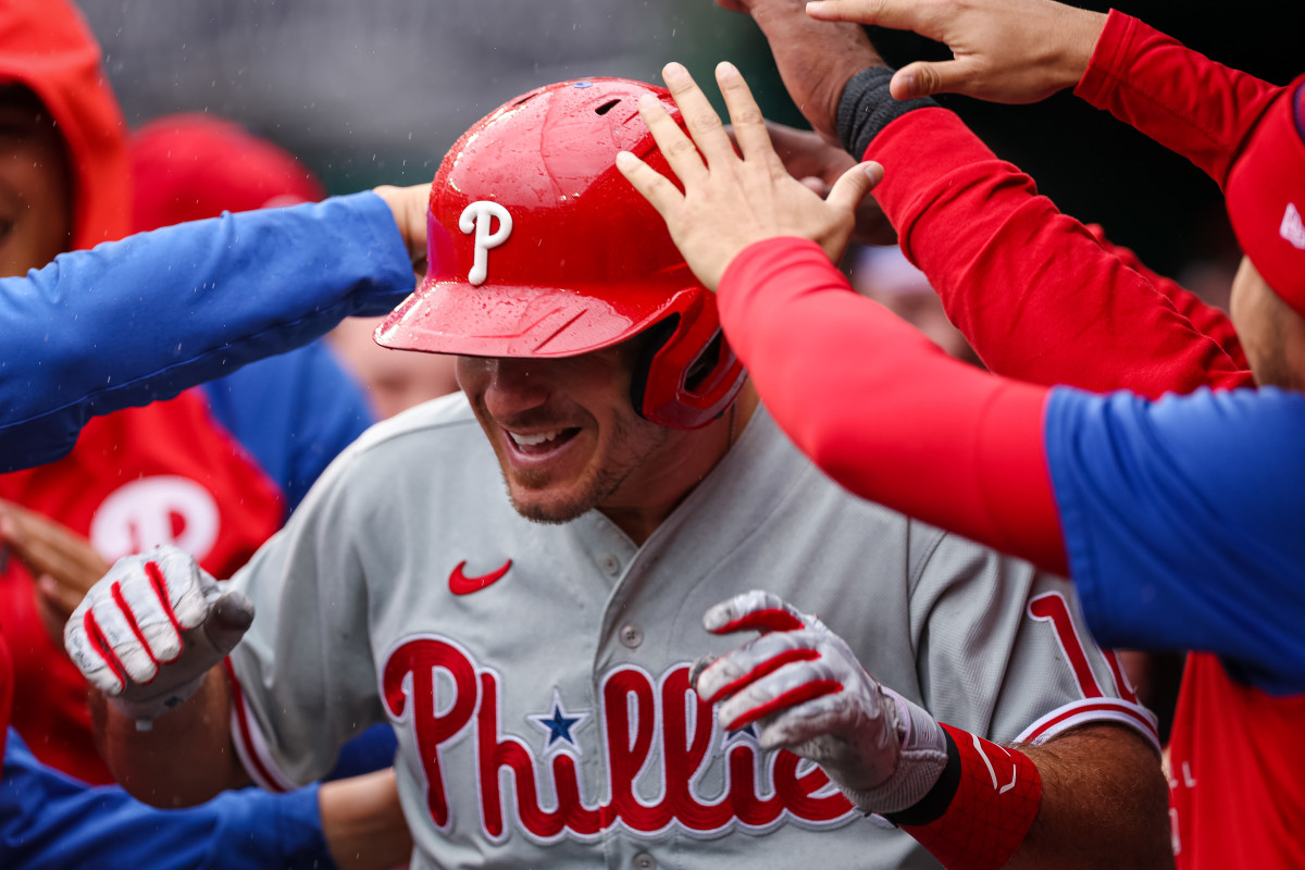 J.T. Realmuto is congratulated by teammates.